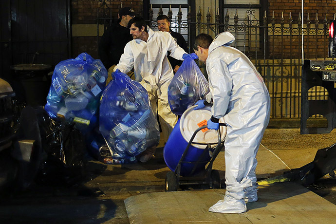 Members of a cleaning crew with "Bio Recovery Corporation" wearing personal protective equipment (PPE) push a barrel to be loaded in a truck of Centers for Disease Control and Prevention (CDC) after cleaning the apartment where Dr. Craig Spencer lives in New York October 24, 2014. (Reuters/Eduardo Munoz)