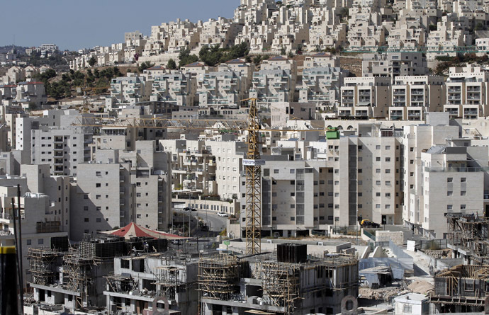 A partial view taken on October 29, 2014 shows cranes used to construct new buildings in the Israeli settlement of Har Homa, which was originally built in the 1990s, in the annexed Arab east Jerusalem area of Jabal Abu Ghneim. (AFP Photo/Ahmad Gharabli)