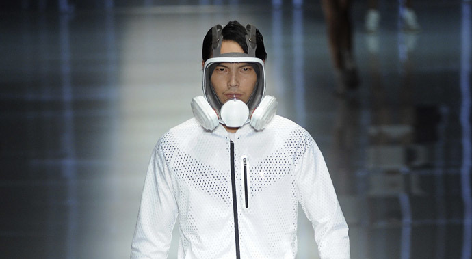 A model wearing a mask presents a creation at the QIAODAN Yin Peng Sports Wear Collection show during China Fashion Week in Beijing, October 28, 2014. (Reuters/Stringer)