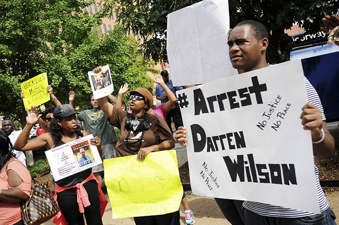 Protestors at the St. Louis County Justice Center call for the arrest of Police Officer Darren Wilson in Clayton, Missouri August 20, 2014. (Reuters/Mark Kauzlarich)