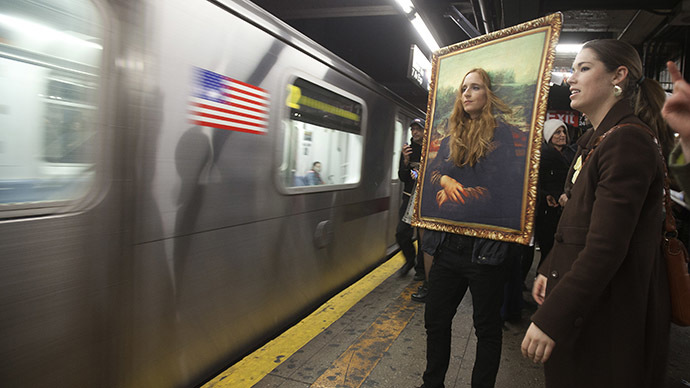 A participant in the Village Halloween Parade dressed as the Mona Lisa waits to ride the subway after the parade in the Manhattan borough of New York October 31, 2014. (Reuters/Carlo Allegri)