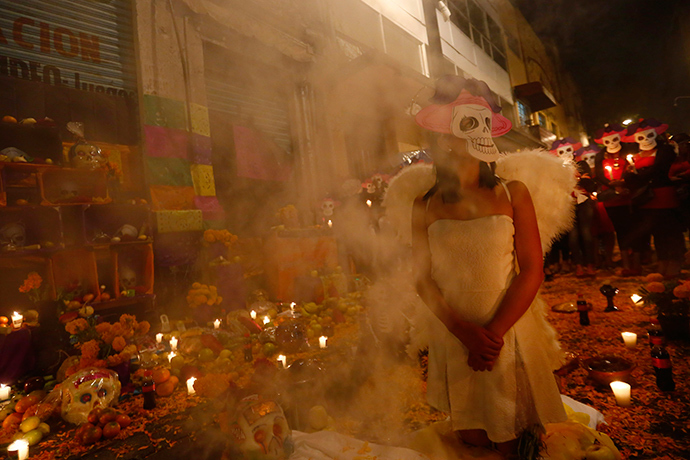 Sex workers wear skeleton masks, a traditional Mexican symbol representing the Day of the Dead, as they make an offering during a procession to remember their deceased colleagues, especially those who were violently murdered, in Mexico City (Reuters / Edgard Garrido)