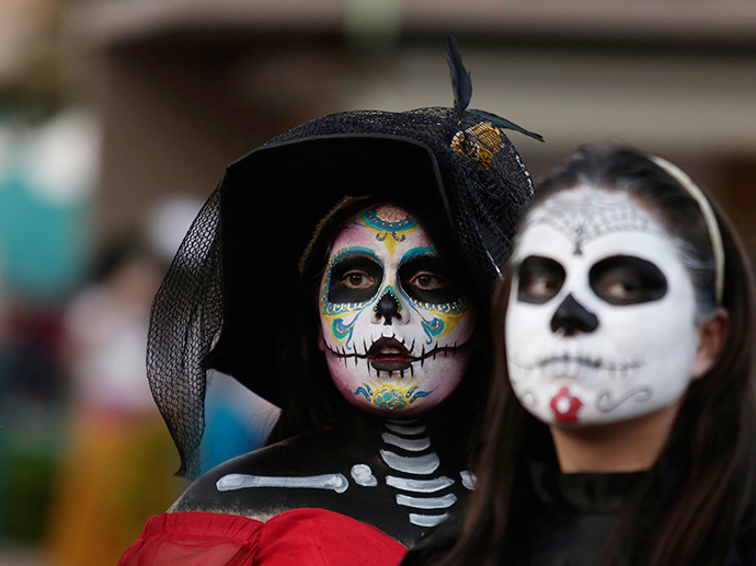 Women with faces painted to look like the popular Mexican figure called "Catrina" are seen in Zapopan (Reuters / Alejandro Acosta)