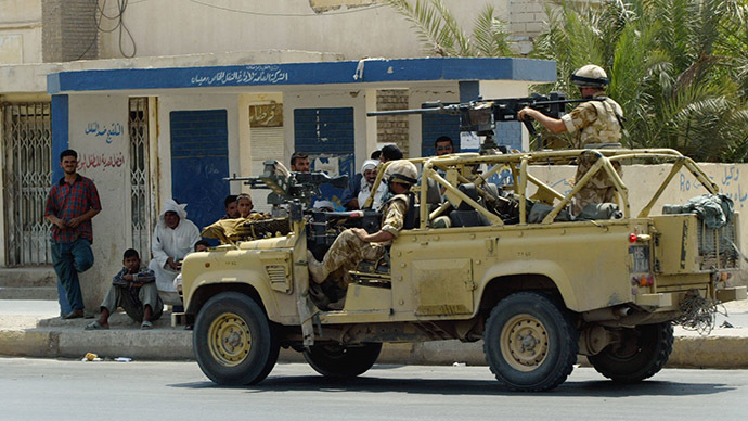 British soldiers wearing their combat helmets June 26, 2003 patrol in Amarah, 350 km southeast of Baghdad. (Reuters/Radu Sigheti)