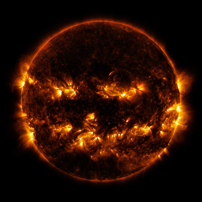 This NASA image obtained October 10, 2014 shows active regions on the sun as they gave it the appearance of a jack-o'-lantern. This image was captured by the Solar Dynamics Observatory on October 8, 2014 (AFP Photo / NASA)