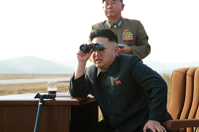 North Korean leader Kim Jong Un looks through a pair of binoculars as he guides a flight drill for the inspection of airmen of the Korean People's Army (KPA) Air and Anti-Air Force in this undated photo released by North Korea's Korean Central News Agency (KCNA) in Pyongyang October 30, 2014 (Reuters / KCNA)