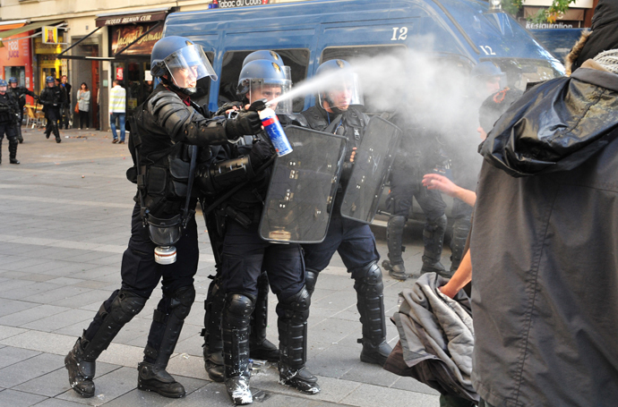 Police officers spray tear gas on November 1, 2014 in Nantes (AFP Photo / Georges Gobet)