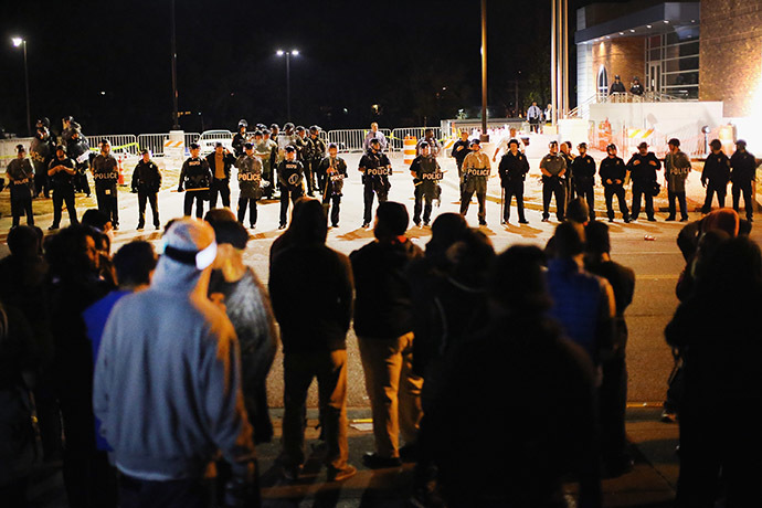 Police face off with demonstrators outside the police station as protests continue in the wake of 18-year-old Michael Brown's death on October 22, 2014 in Ferguson, Missouri. (AFP Photo/Scott Olson)