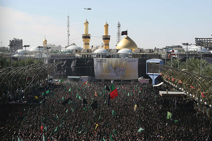 Iraqi Shiite Muslims gather outside the shrine of Imam Hussein -one of Shiite Islam's most revered figures- during the Ashura commemorations that mark his killing on November 4, 2014. (AFP Photo/Mohammed Sawaf)