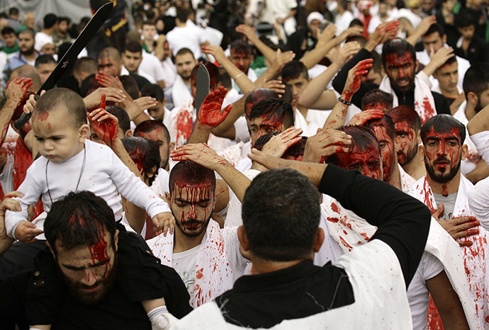 Lebanese Shiite Muslims take part in a self-flagellation procession during the Ashura commemorations that mark the killing of Imam Hussein -one of Shiite Islam's most revered figures- on November 4, 2014 in the southern Lebanese city of Nabatiyeh.(AFP Photo/Mahmoud Zayyat)