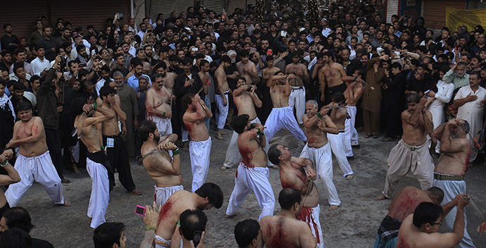 Pakistani Shi'ite Muslim men flagellate to commemorate Ashoura in Peshawar November 4, 2014. (Reuters/Fayaz Aziz)