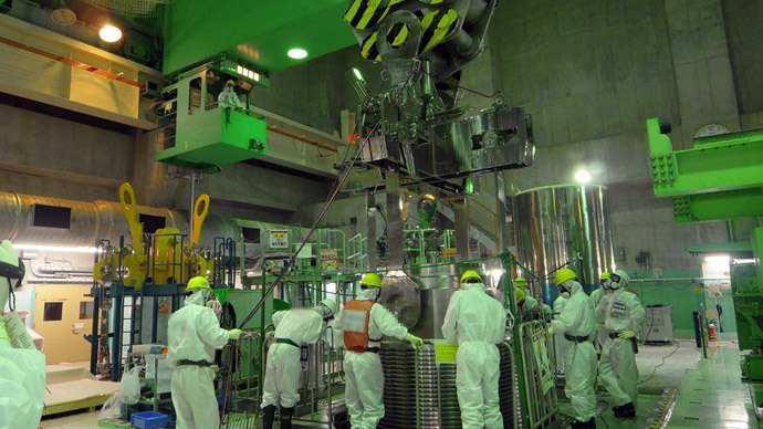 Workers at Reactor 4 building. Photo by Tepco.