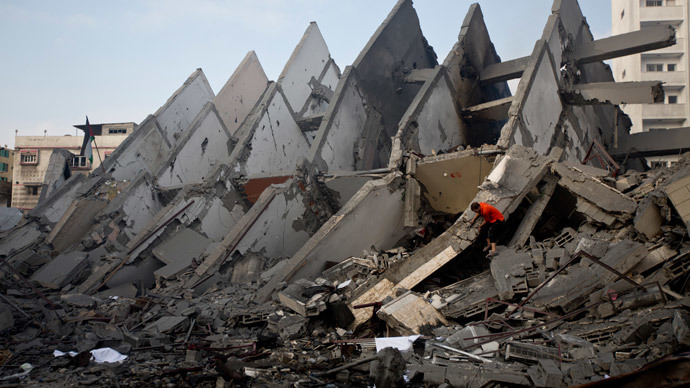 A Palestinian inspects the remains of a building that was destroyed by an Israeli air strike in Gaza City on August 26, 2014.(AFP Photo / Mahmud Hams)