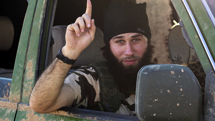 An Islamic State fighter gestures from a vehicle in the countryside of the Syrian Kurdish town of Kobani, after the Islamic State fighters took control of the area October 7, 2014. (Reuters / Stringer)