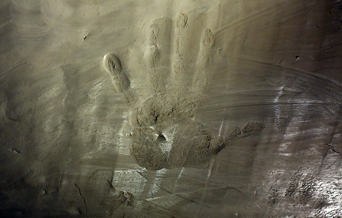 An impression of the hand of former Soviet President Mikhail Gorbachev is seen in cement as he visits the former Berlin Wall border crossing point Checkpoint Charlie, in Berlin November 7, 2014.(Reuters/Hannibal Hanschke)