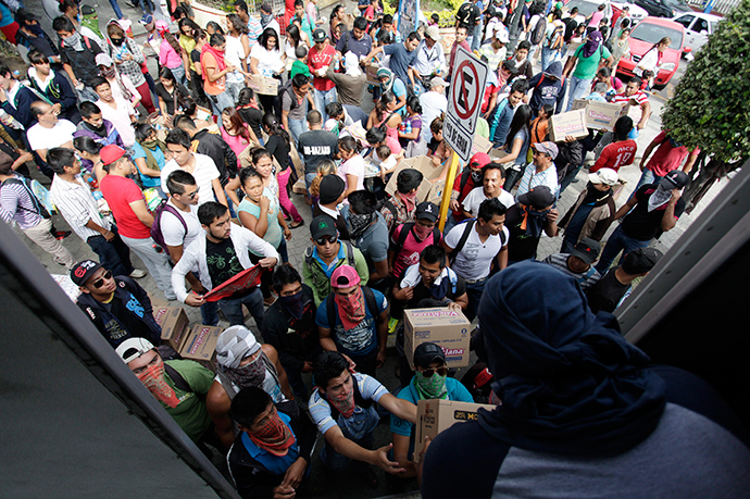 Student teachers hand out merchandise from a truck, which they blocked on a highway, during a protest in support of 43 missing students, in Chilpancingo, November 7, 2014 (Reuters / Daniel Becerril)