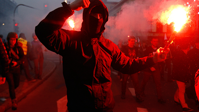 A far-right protester holds a flare during the annual far-right rally, which coincides with Poland's National Independence Day in Warsaw November 11, 2014 (Reuters / Kacper Pempel)