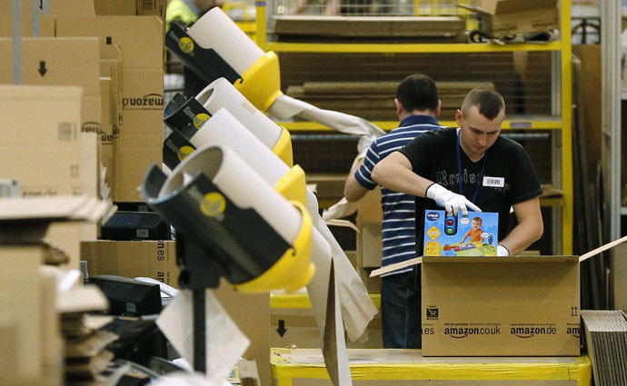 A worker packs completed orders into boxes at the Amazon fulfilment centre in Peterborough, central England (Reuters/Phil Noble)