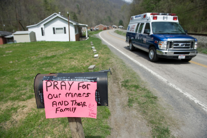 An ambulance drives by a sign praying for miners in Eunice, West Virginia, April 7, 2010, near the Upper Big Branch coal mine owned by Massey Energy Company and operated by Performance Coal Company in Montcoal where an explosion killed 25 miners with 4 still unaccounted for. (AFP Photo / Saul Loeb)