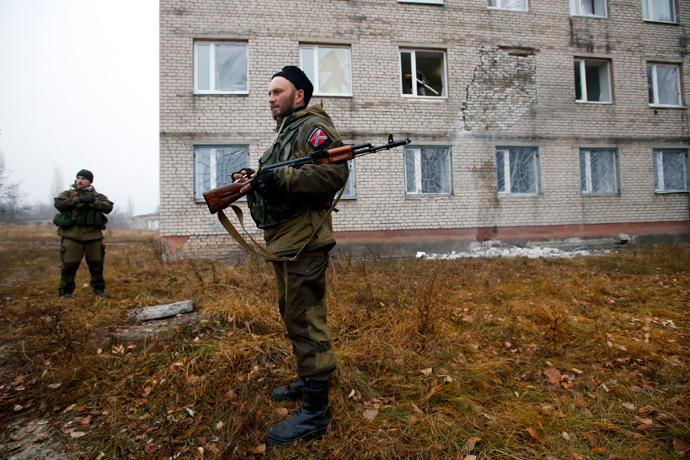 A rebels stand guard outside the building of perinatal centre damaged by, what locals say, was shelling by Ukrainian forces in the town of Pervomaisk, west of Lugansk, eastern Ukraine (Reuters / Maxim Zmeyev)