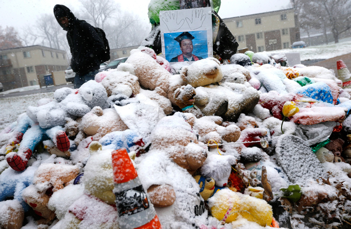 A man walks past a memorial set up at the scene where Michael Brown was shot and killed in Ferguson, Missouri November 16, 2014 (Reuters / Jim Young)