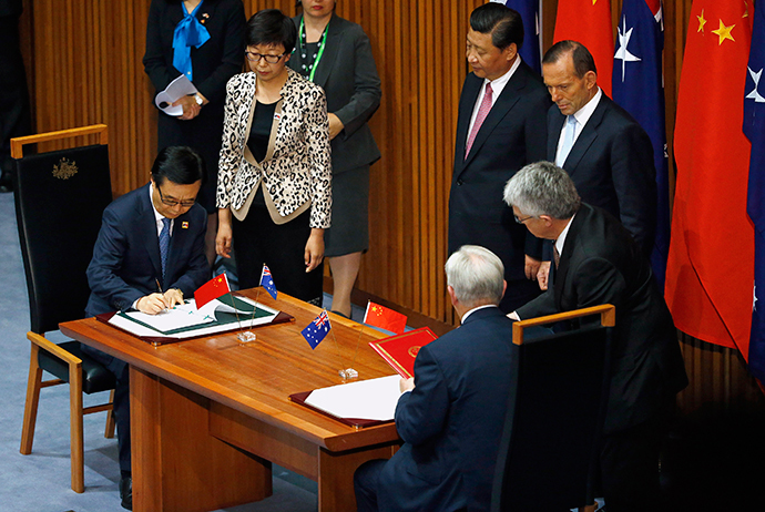 China`s President Xi Jinping (C) watches the signing ceremony with Australian Prime Minister Tony Abbott for a free trade deal at Parliament House in Canberra November 17, 2014. (Reuters / David Gray)