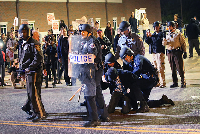 Police arrest a demonstrator outside the police station as protests continue in the wake of 18-year-old Michael Brown's death on October 22, 2014 in Ferguson, Missouri. (Scott Olson / Getty Images / AFP)
