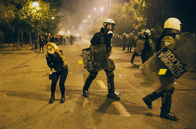 A protester reacts after inhaling tear gas during scuffles with the police at a rally marking the 41st anniversary of a 1973 student uprising against a U.S. backed military dictatorship in then ruling Greece, near the U.S. embassy in Athens November 17, 2014. (Reuters / Yannis Behrakis)