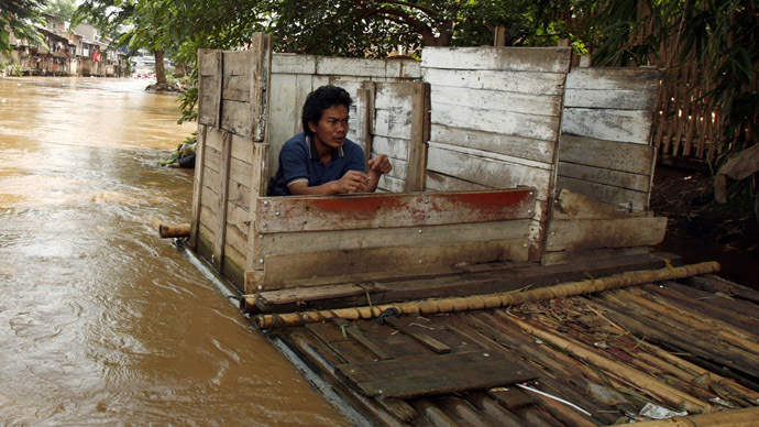 A resident uses a floating public toilet on the Ciliwung river bank in Jakarta (Reuters/Beawiharta)