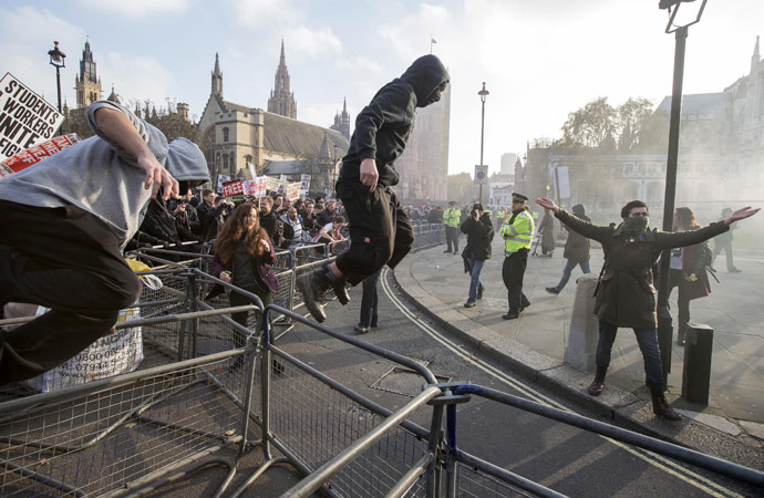 Demonstrators break through barricades in Parliament Square in front of the Houses of Parliament, as they participate in a protest against student loans and in favour of free education, in central London November 19, 2014. (Reuters/Peter Nicholls)