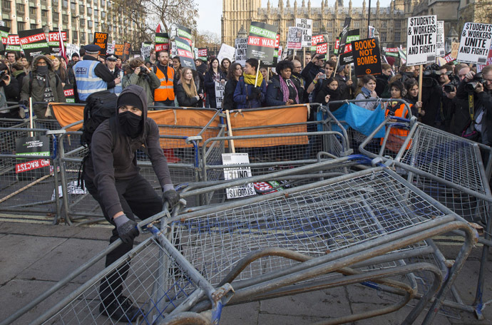 Demonstrators break through barricades in Parliament Square in front of the Houses of Parliament, as they participate in a protest against student loans and in favour of free education, in central London November 19, 2014. (Reuters/Peter Nicholls)