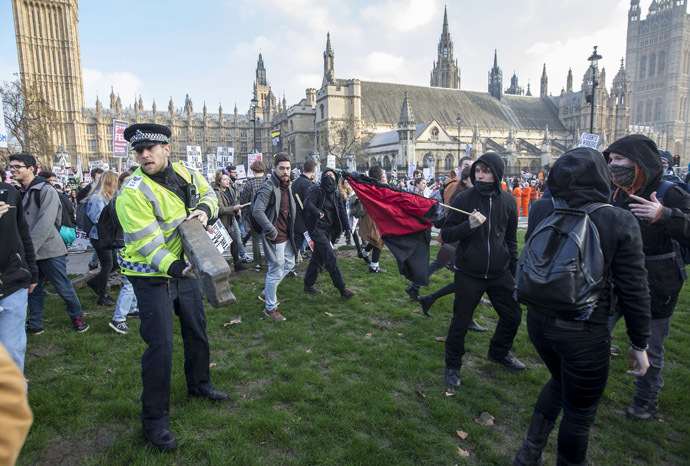 Demonstrators walk in Parliament Square in front of the Houses of Parliament, as they participate in a protest against student loans and in favour of free education, in central London November 19, 2014. (Reuters/Peter Nicholls)