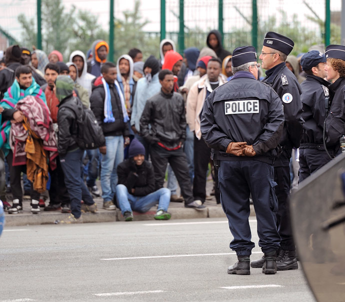 Illegal immigrants wait to be expelled from their camp at Calais on May 28, 2014. (AFP Photo/Denis Charlet)