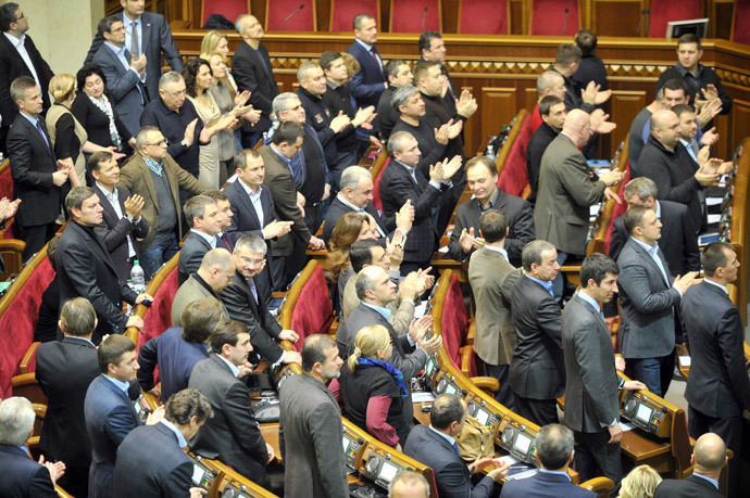 Deputies of the Ukrainian parliament applaud after voting for a constitution change in Kiev on February 21, 2014. (AFP Photo / Genya Savilov)