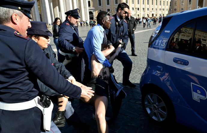 Femen activists protest in St.Peter's Square on November 14, 2014 at the Vatican. (AFP Photo / Alberto Pizzoli)