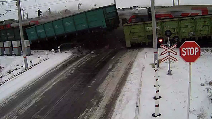Truck torn apart by 2 trains at rail crossing in Kazakhstan (VIDEO)
