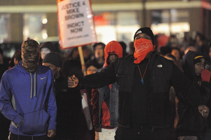 Demonstrators gather outside the Ferguson Police Department in Ferguson Missouri, on November 24, 2014 to protest the death of 18-year-old unarmed black teenager Michael Brown, who was shot to death by a white police officer. (AFP Photo/Michael B. Thomas)