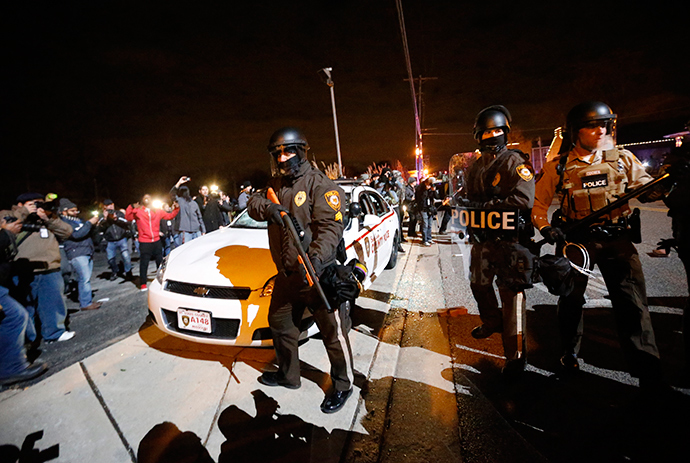 Police officers stand next to a vandalized police car outside the Ferguson Police Department in Ferguson, Missouri, after a grand jury returned no indictment in the shooting of Michael Brown November 24, 2014 (Reuters / Jim Young)