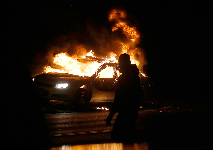 A car burns on the street after a grand jury returned no indictment in the shooting of Michael Brown in Ferguson, Missouri November 24, 2014 (Reuters / Jim Young)