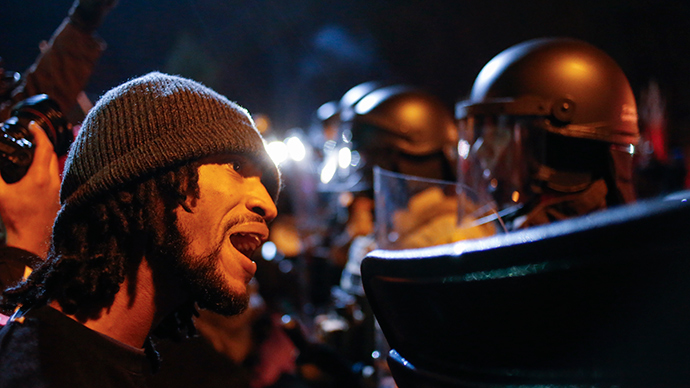 A protester confronts a police officer after a grand jury returned no indictment in the shooting of Michael Brown in Ferguson, Missouri, November 24, 2014 (Reuters / Adrees Latif)