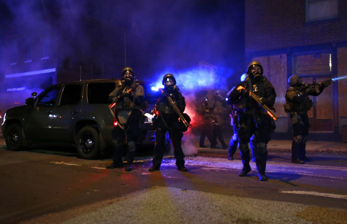 Police wearing gas masks stand at the ready as tear gas fills the air in Ferguson, Missouri, November 25, 2014. (Reuters/Adrees Latif)