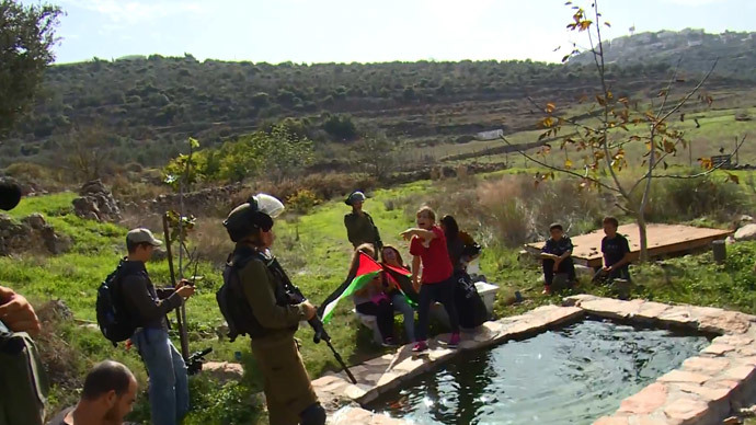 8-year-old Jana Tamimi confronts Israeli soldiers near her home villageâNabi Saleh in the West Bank.(A screenshot from a video by YouTube user David Reeb)