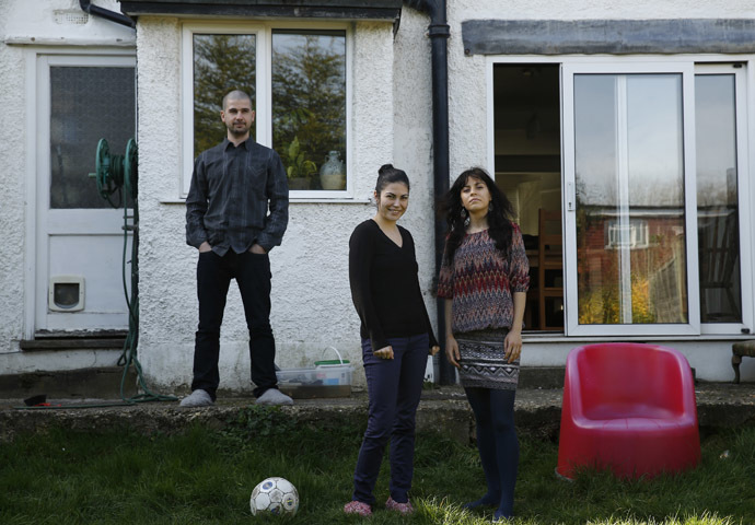 Romanian migrants Marius Spiridon and sisters Mihaela and Andreea Toniciuc (R) pose in the garden of the house where Marius lodges, after an interview with Reuters in Hendon, north London March 15, 2014. (Reuters/Luke MacGregor)