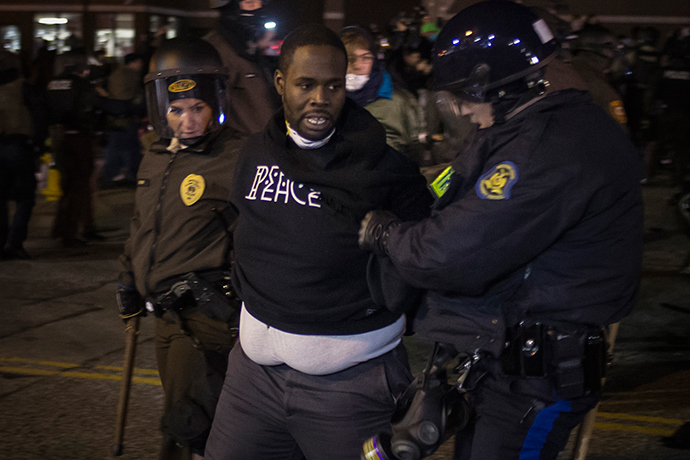 Police detain a man, who was demanding justice for the killing of 18-year-old Michael Brown, outside the Ferguson Police Department in Missouri November 28, 2014 (Reuters / Adrees Latif)