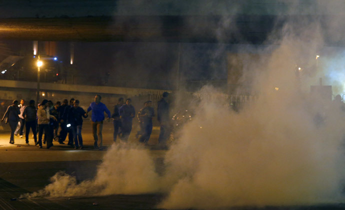 Anti-Mubarak protesters run from tear gas fired by riot police during a protest after former Egyptian President Hosni Mubarak's verdict, around Abdel Moneim Riad square, which leads to Tahrir square in downtown Cairo November 29, 2014. (Reuters/Amr Abdallah Dalsh)