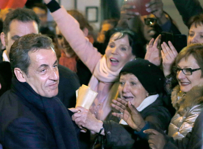 Former French president Nicolas Sarkozy (L) is greeted by well-wishers as he leaves his campaign headquarters after he won his UMP (Union for a Movement Popular) politial party member's online vote for its new leader in Paris November 29, 2014. (Reuters/Gonzalo Fuentes)