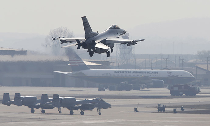 A F-16 fighter jet (top) belonging to the U.S. Air Force comes in for a landing at a U.S. air force base in Osan, south of Seoul April 3, 2013. (Reuters/Lee Jae-Won)