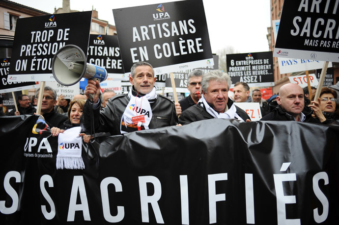 French bosses hold signs as they protest on December 1, 2014 in Toulouse against 30 years of government economic policies that have, according to them, stunted economic growth. (AFP Photo / Remy Gabalda)