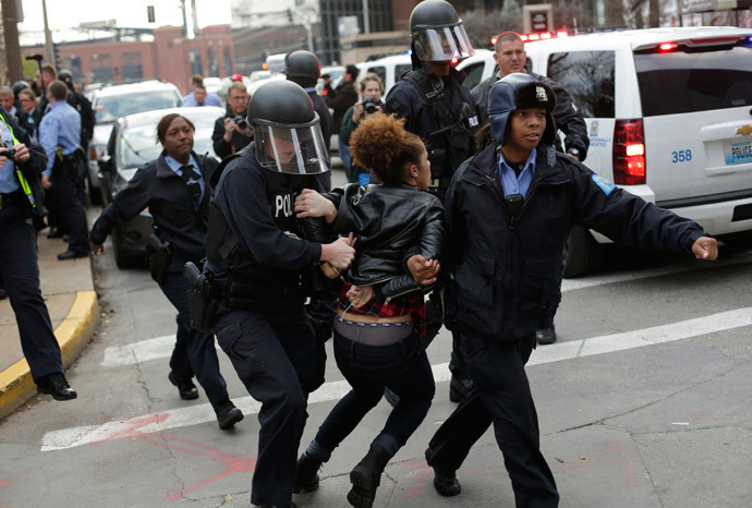 A demonstrator protesting the shooting death of Michael Brown is arrested by police officers in riot gear November 30, 2014 in St. Louis, Missouri. (Joshua Lott / Getty Images / AFP)