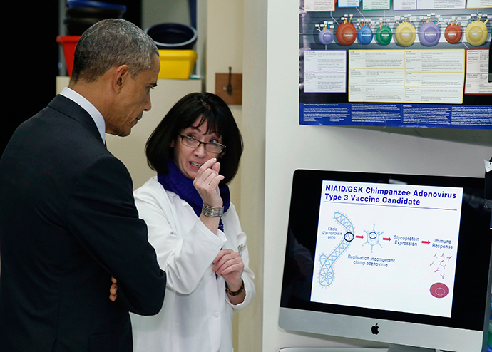 U.S. President Barack Obama listens as Dr. Nancy Sullivan talks about Ebola in the Vaccine Research Center during his visit to the National Institutes of Health in Bethesda, Maryland December 2, 2014 (Reuters / Larry Downing)